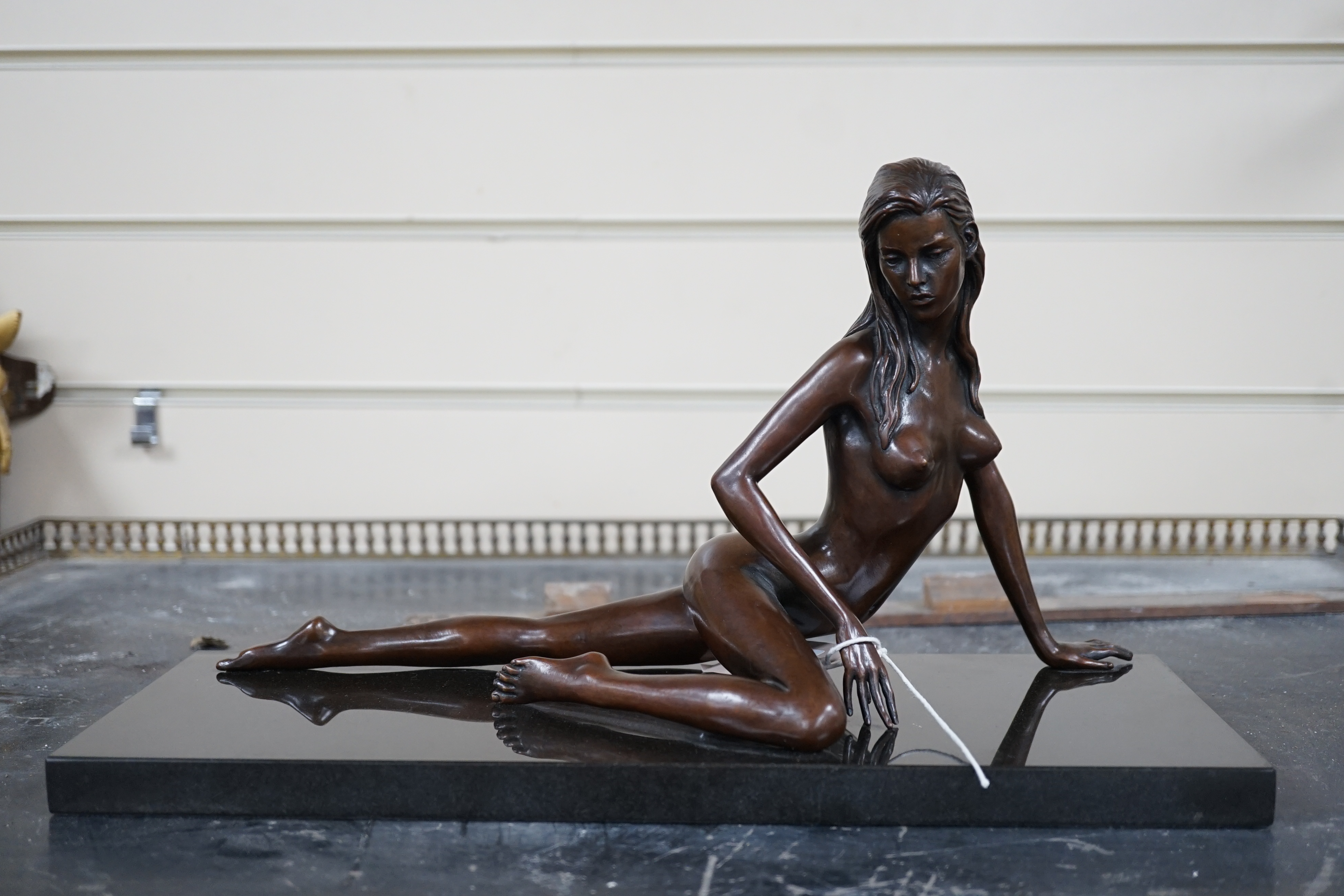 Jonathan Wylder (born 1957). A bronze reclining nude 'Prague', one of edition of eight, 38cm wide, 21cm high